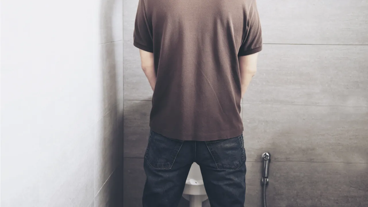 What are the dangers of urinating while standing?